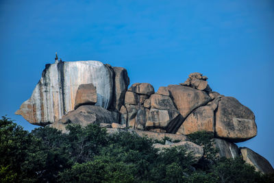 Rock formation against clear blue sky