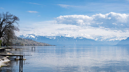 Scenic view of sea and mountains against sky