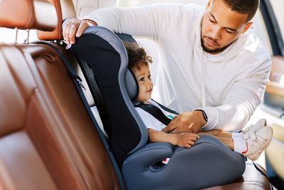 Father with son sitting in car