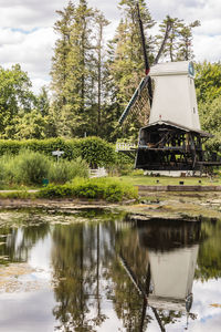 Built structure by lake against trees