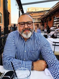 Portrait of man sitting on table
