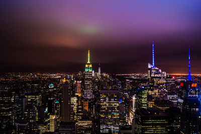 Illuminated cityscape against sky at night