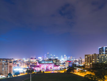 High angle view of illuminated buildings against sky at night