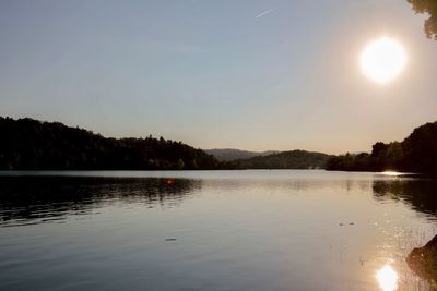 Scenic view of lake against clear sky at sunset