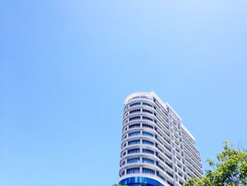 Low angle view of modern building against clear blue sky