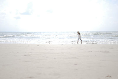 Man on beach against sky