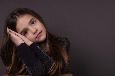 Portrait of beautiful woman against black background