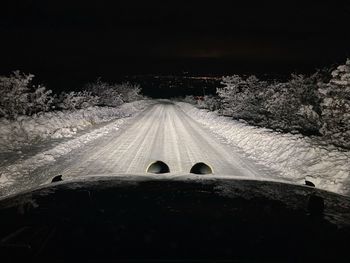 Snow covered road at night