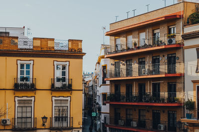 Traditional colourful buildings with balconies on a street in seville, spain.