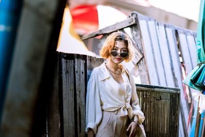 Young woman wearing sunglasses standing outdoors