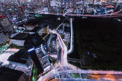 High angle view of city lit up at night