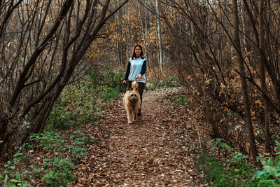 Portrait of man with dog in forest