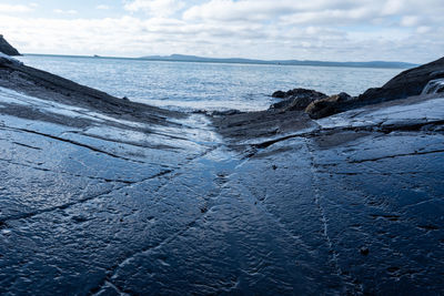 Scenic view of sea against sky from cured stone surface