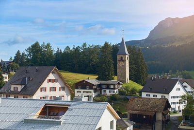 Buildings in town against sky