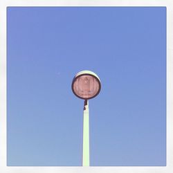 Low angle view of trees against clear blue sky