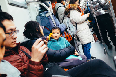 Rear view of people sitting in car