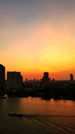 Scenic view of silhouette buildings against sky during sunset