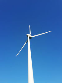 Low angle view of wind turbine against clear sky