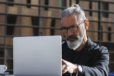 Midsection of man using mobile phone