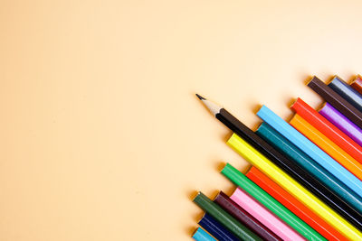 High angle view of colored pencils on white background