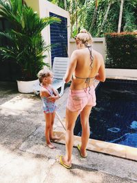 Full length of mother and daughter in swimming pool
