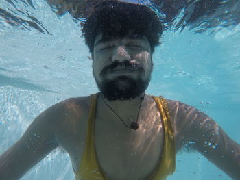 Young man swimming in sea