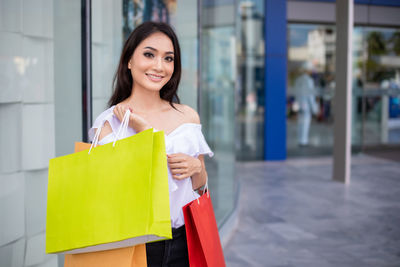 Portrait of smiling woman standing outdoors