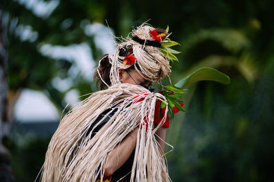 Woman with plants standing outdoors