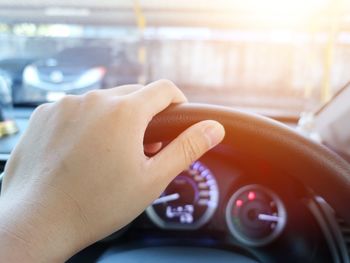 Close-up of person driving car