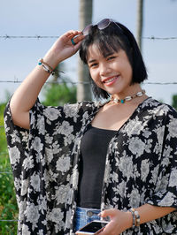 Portrait of a smiling young woman standing outdoors