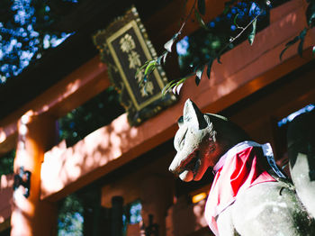 Low angle view of statue against temple