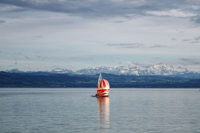 Sailboat in sea against sky