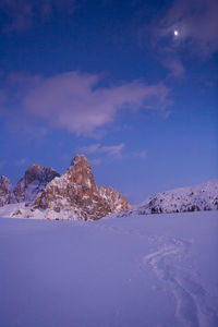 Snow covered mountain against blue sky