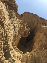 Low angle view of rock formation against sky