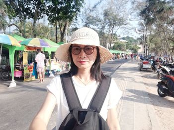 Portrait of mature woman wearing hat on road