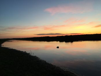 Scenic view of lake against romantic sky at sunset