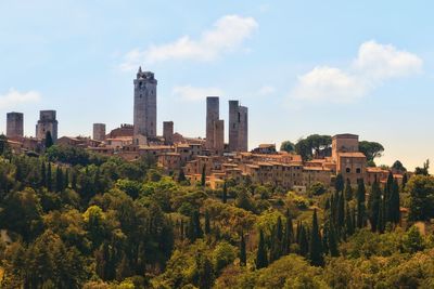 Panoramic view of trees and buildings against sky