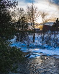 Scenic view of river against sky during winter