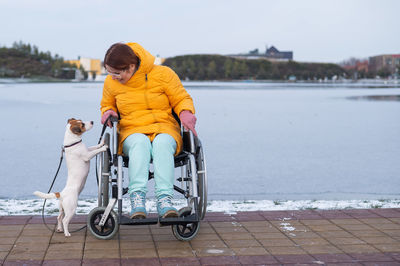 Rear view of man sitting on wheelchair