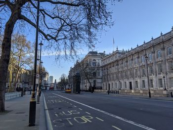 Road by building against sky in city