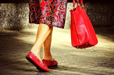 Low section of woman standing on red floor