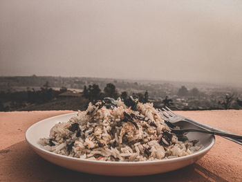 Close-up of food in bowl against sky