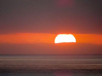 Scenic view of sea against romantic sky at sunset