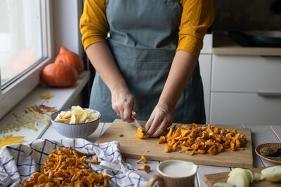 Midsection of man preparing food at home