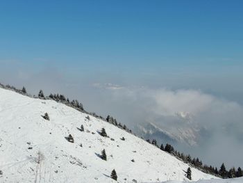 Scenic view of snow covered mountains against sky