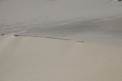 High angle view of wet sand on beach