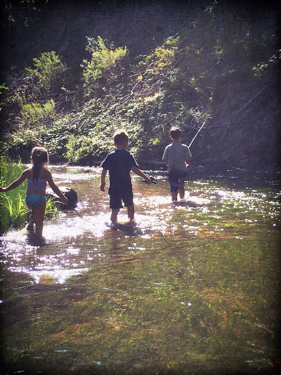 TWO CHILDREN PLAYING IN WATER