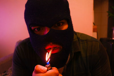 Close-up of thief lighting cigarette