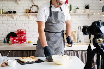 Full length of man standing at table