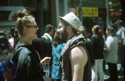 Rear view of people looking at camera